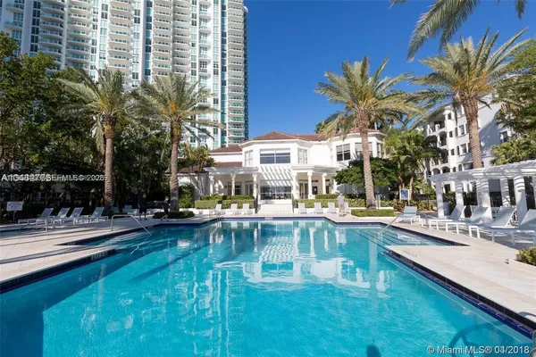 a view of a swimming pool with outdoor seating