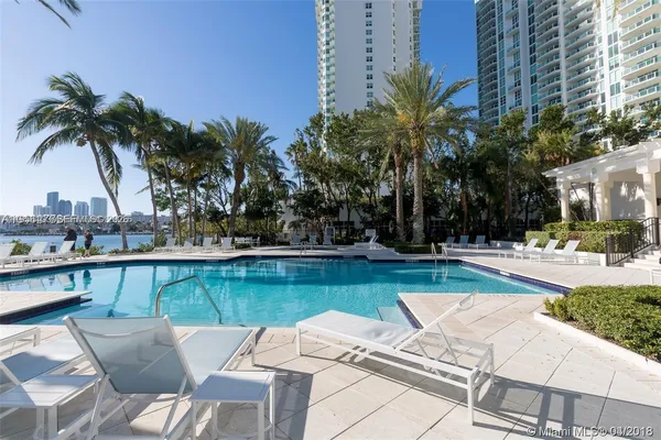 a view of swimming pool with outdoor seating and plants