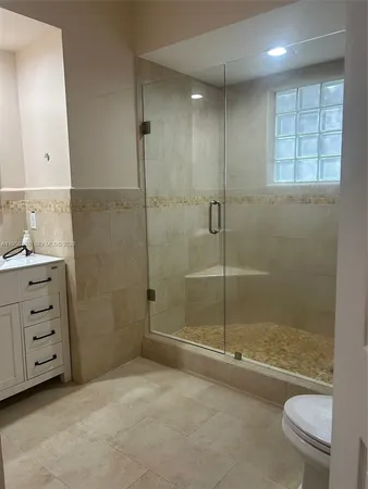 a bathroom with a shower a toilet and a sink