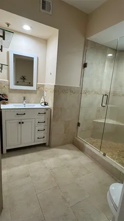 a bathroom with a tub a sink and mirror