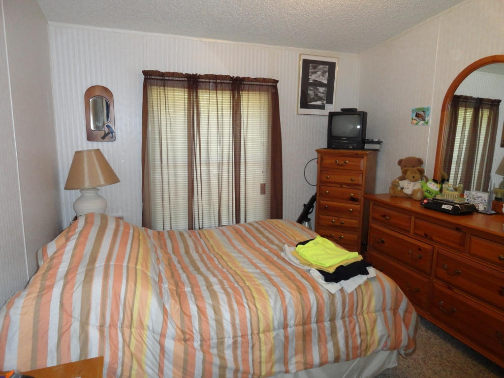 339 East Nursery Road Santa Rosa Beach, FL 32459 - Photo 23 of 32 a bedroom with a bed and wooden floor