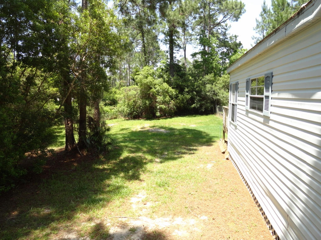 339 East Nursery Road Santa Rosa Beach, FL 32459 - Photo 24 of 32 a view of a yard with large trees