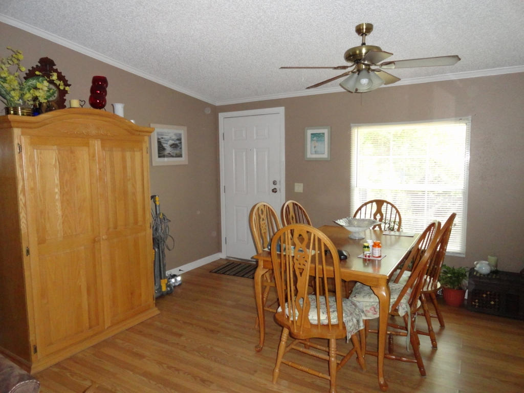 339 East Nursery Road Santa Rosa Beach, FL 32459 - Photo 7 of 32 a view of a dining room with furniture window and wooden floor