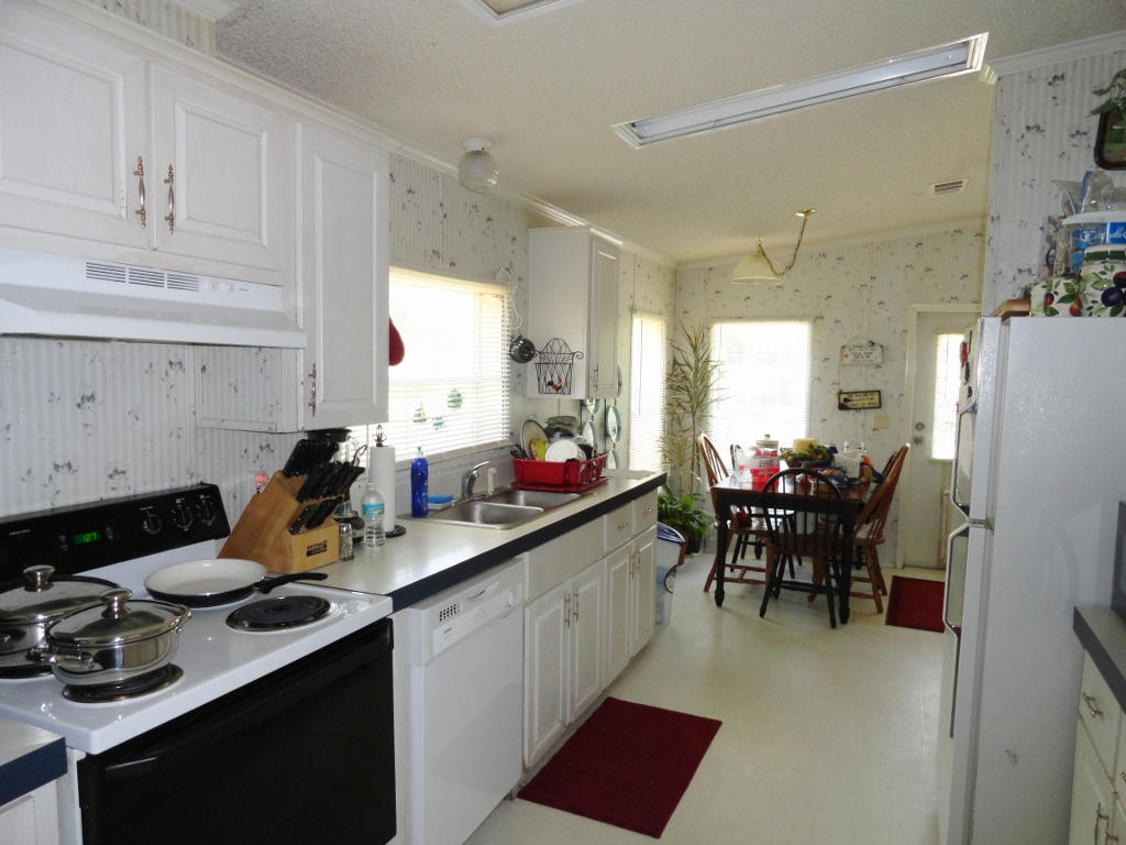 339 East Nursery Road Santa Rosa Beach, FL 32459 - Photo 9 of 32 a kitchen with a sink appliances and cabinets