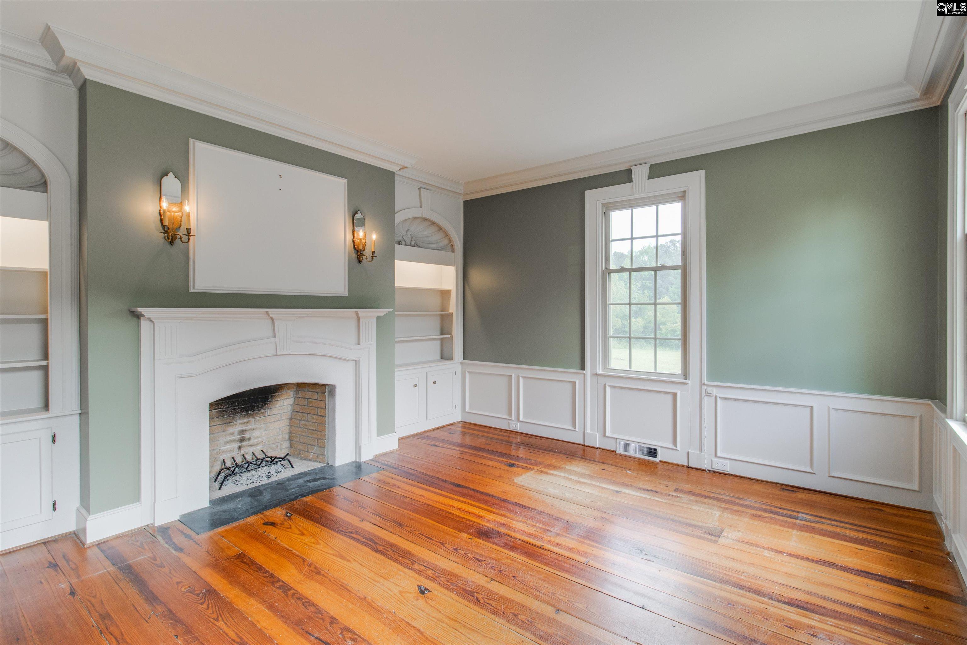 701 Longtown Road Columbia, SC 29229 - Photo 4 of 26 a view of empty room with wooden floor and fireplace