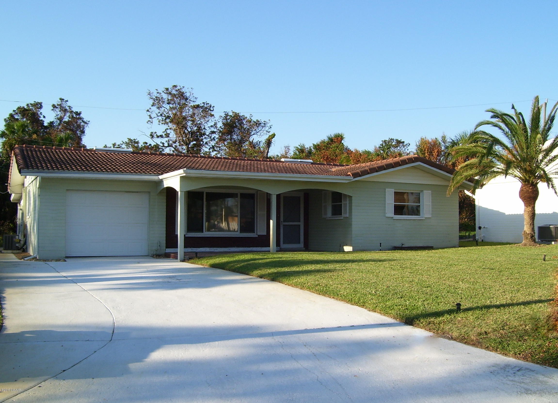a view of a house with a garden and yard
