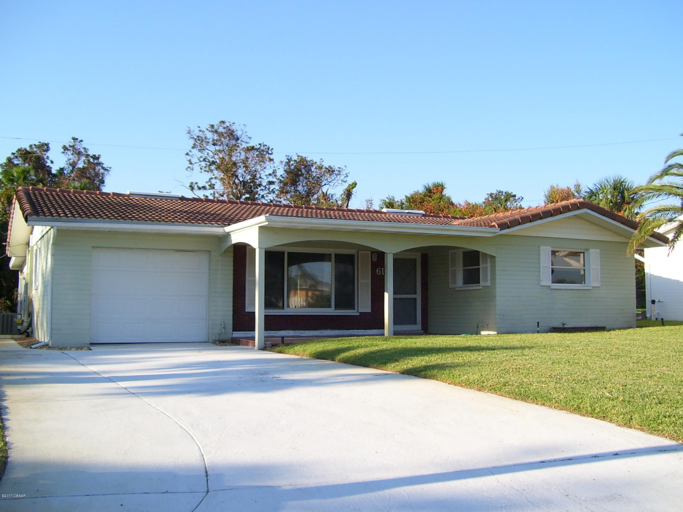 61 Rivocean Drive Ormond Beach, FL 32176 - Photo 17 of 23 a view of a house with a yard and potted plants