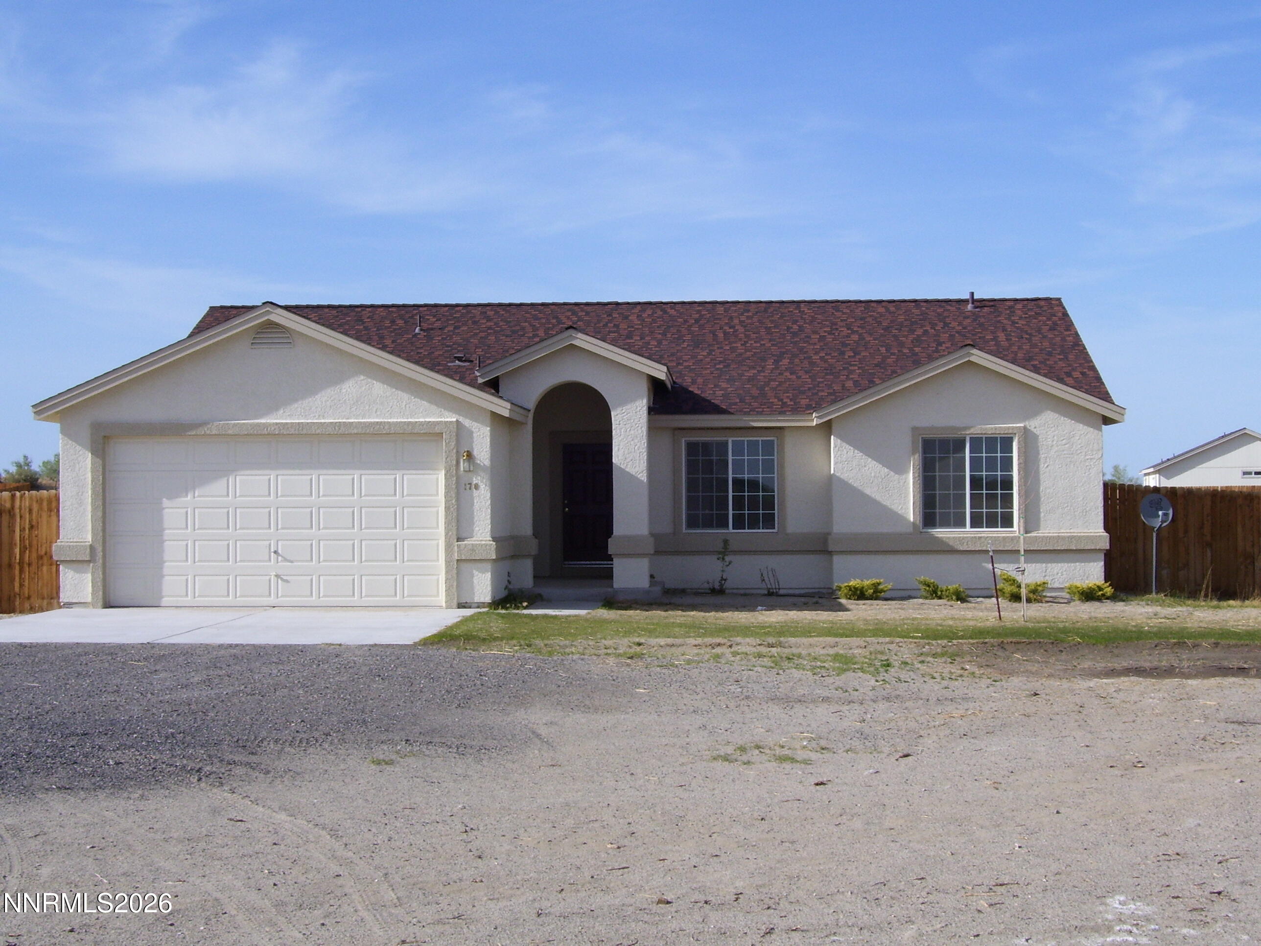 a view of house with a yard and large tree