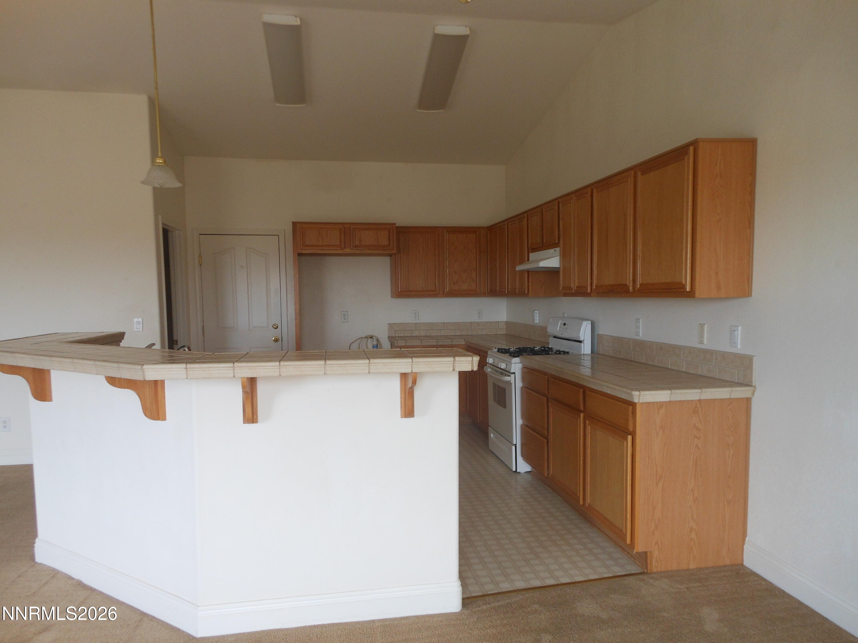 170 Winchester Road Fallon, NV 89406 - Photo 2 of 13 a kitchen with stainless steel appliances granite countertop a stove a sink a refrigerator and a microwave