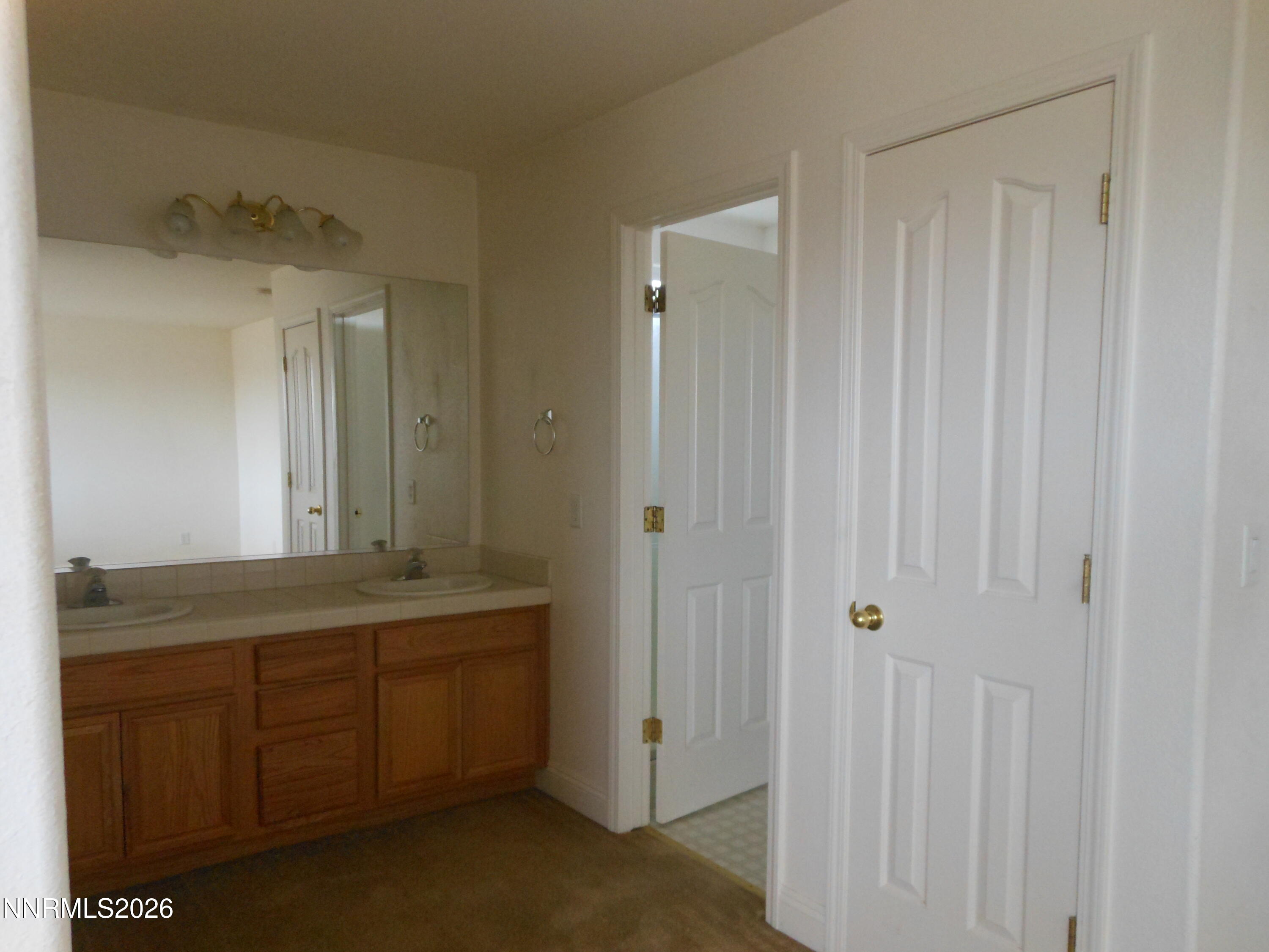 170 Winchester Road Fallon, NV 89406 - Photo 7 of 13 a bathroom with a double vanity sink and mirror