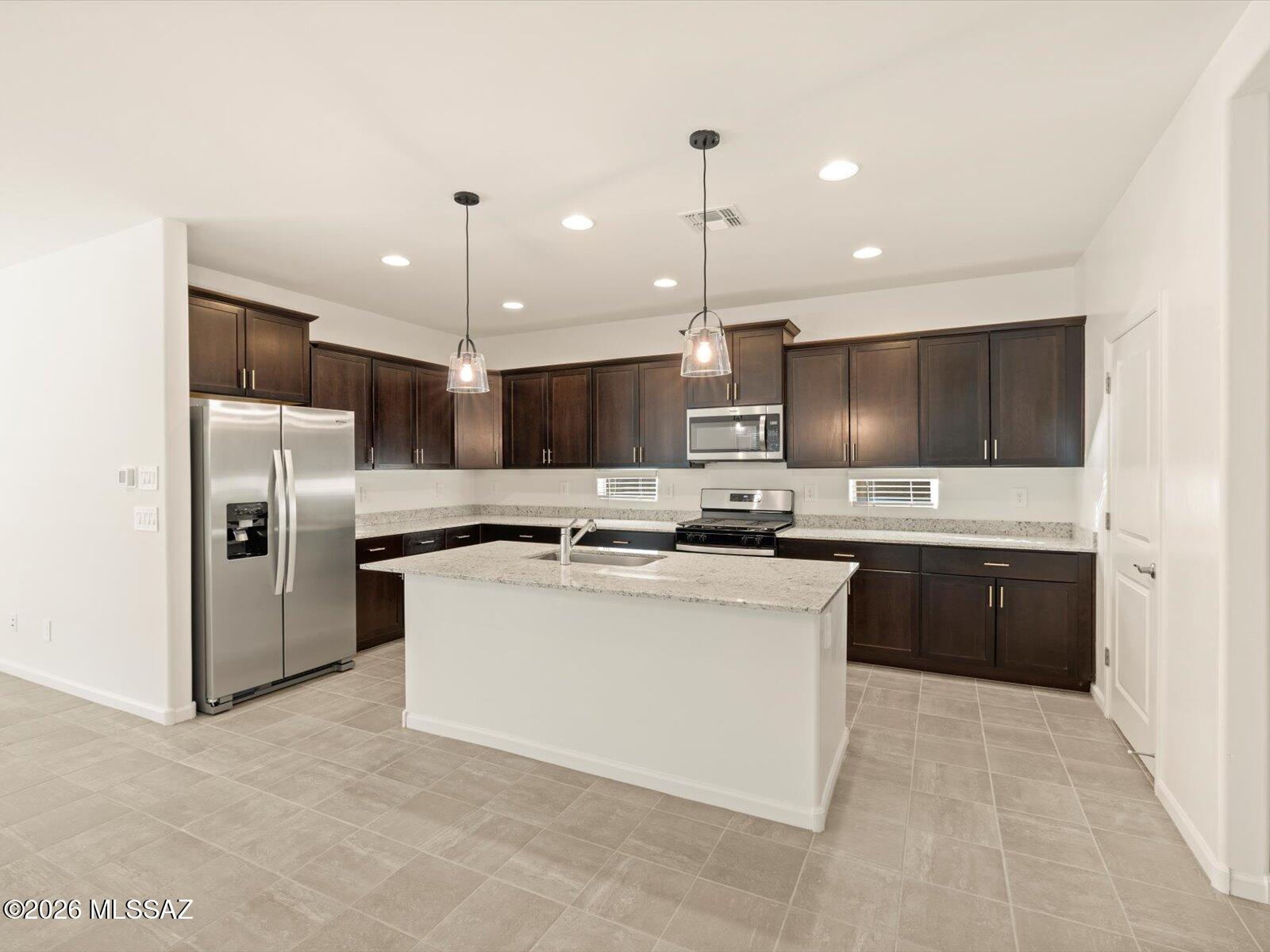 5188 West Bowen House Road Tucson, AZ 85757 - Photo 29 of 32 Photos shown are of a similar floor plan and are intended to provide a close representation of the actual home. Images may include features, finishes, countertops, fixtures, flooring, cabinets, color of cabinets, furnishings, or decorator elements that are not part of the standard offering. While this specific home may include some of these features, please note it may not include all.