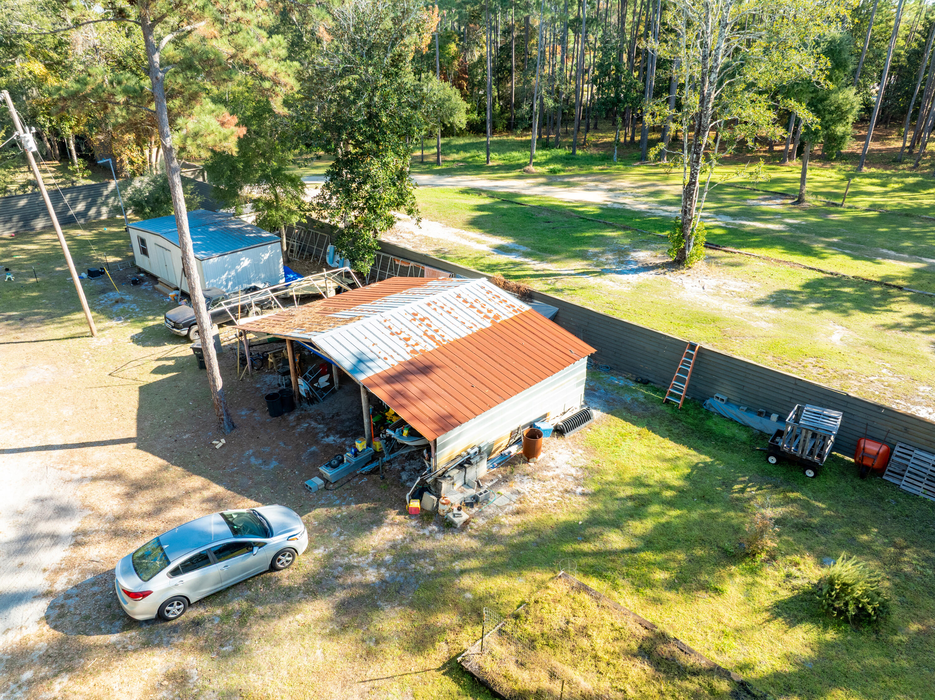 78 B Chat Holley Road Santa Rosa Beach, FL 32459 - Photo 7 of 9 a view of a backyard with a garden and trees