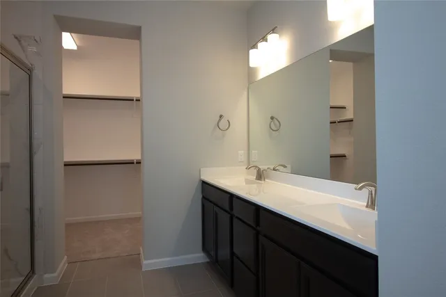 a bathroom with a glass shower door