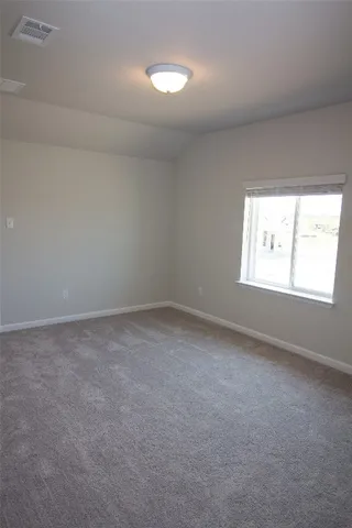 a view of an empty room and closet area