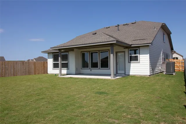 a view of an house with backyard space and garden