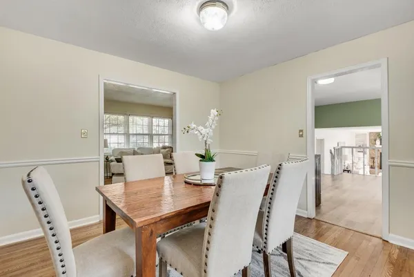 a kitchen with granite countertop a sink a window and cabinets