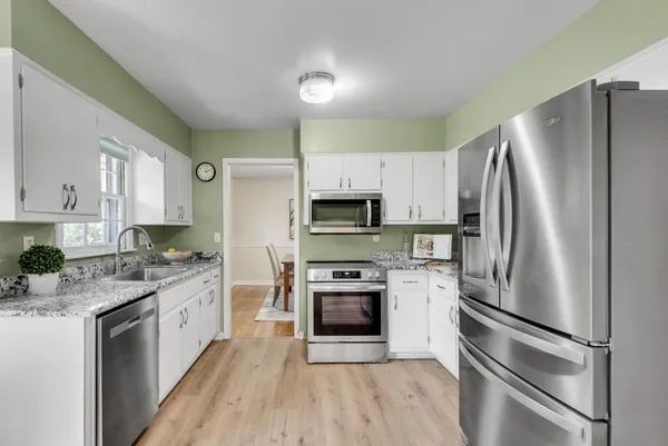a kitchen with stainless steel appliances a refrigerator stove and microwave