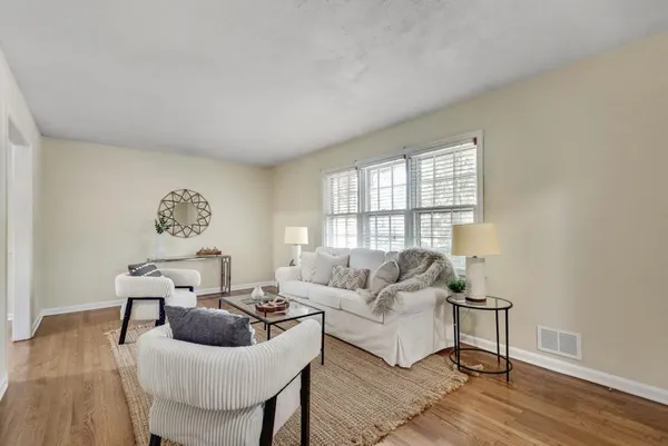 a view of a dining room with furniture and wooden floor