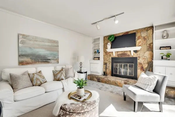 a front view of a house with yard and trees