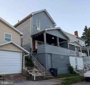 a view of a house with wooden fence