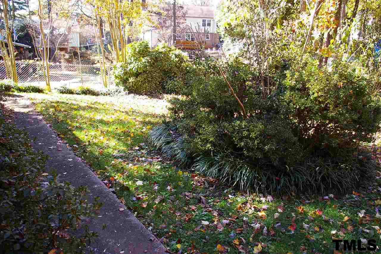2609 Wycliff Road Raleigh, NC 27607 - Photo 11 of 14 a view of a yard with plants and large trees
