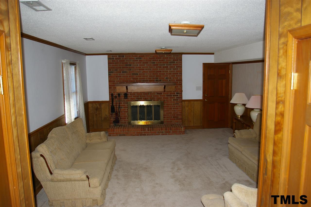 2609 Wycliff Road Raleigh, NC 27607 - Photo 3 of 14 a living room with furniture and a fireplace