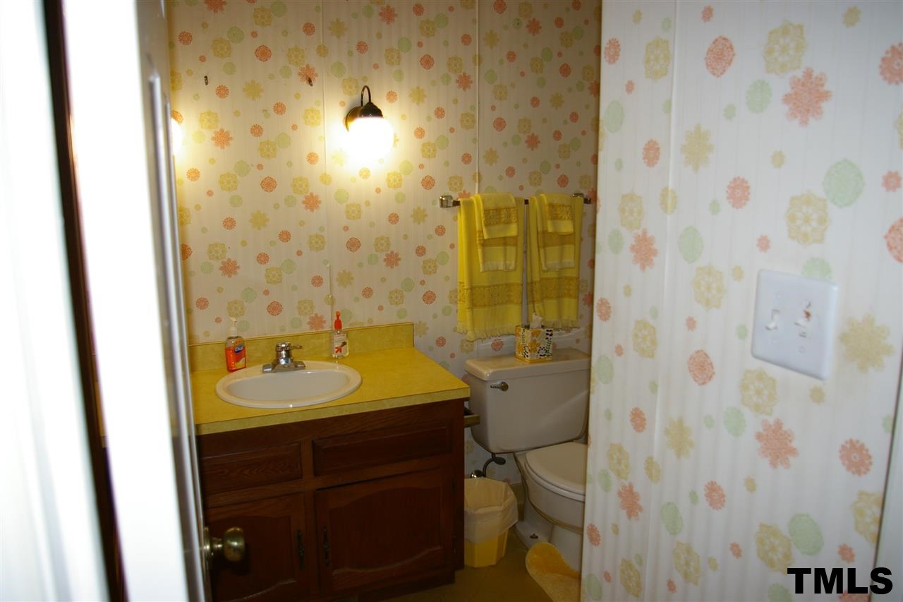 2609 Wycliff Road Raleigh, NC 27607 - Photo 9 of 14 a bathroom with a sink and a mirror