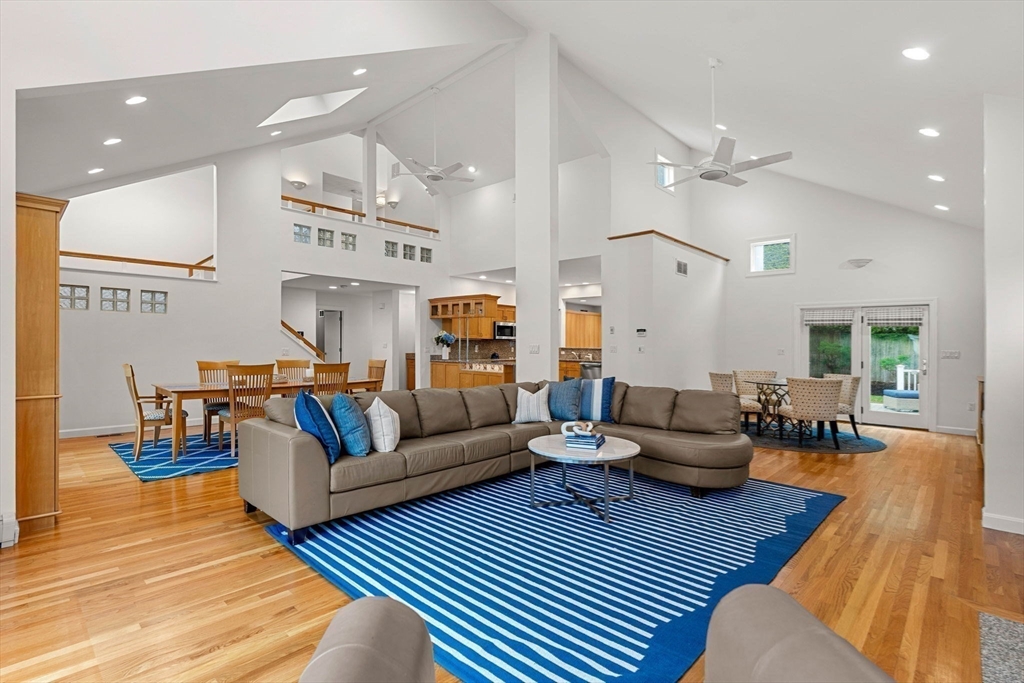a living room with furniture kitchen view and a table