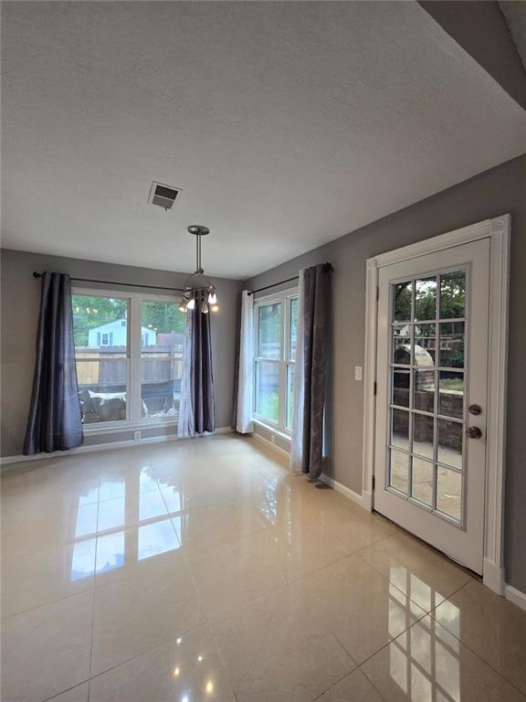 6992 Ivy Pointe Row Austell, GA 30168 - Photo 13 of 32 a view of a big room with windows and chandelier