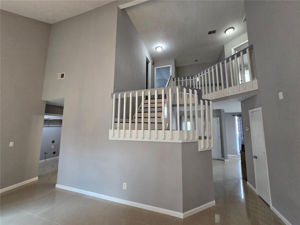 6992 Ivy Pointe Row Austell, GA 30168 - Photo 16 of 32 a view of staircase with white walls