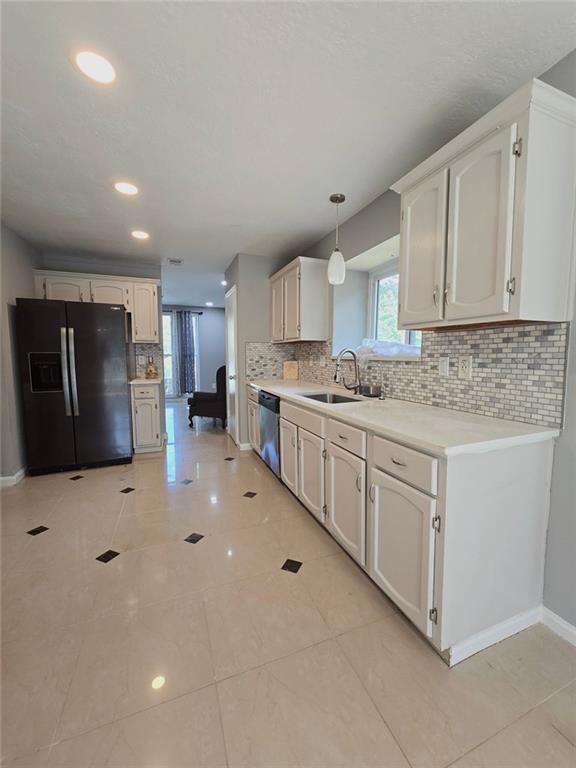 6992 Ivy Pointe Row Austell, GA 30168 - Photo 19 of 32 a kitchen with white cabinets and stainless steel appliances