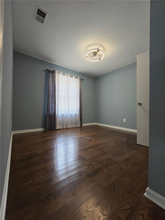 6992 Ivy Pointe Row Austell, GA 30168 - Photo 23 of 32 an empty room with wooden floor and windows