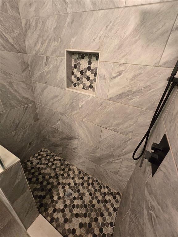 6992 Ivy Pointe Row Austell, GA 30168 - Photo 25 of 32 a bathroom with a toilet and a shower