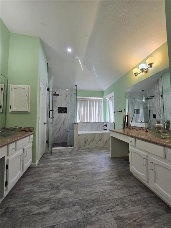 6992 Ivy Pointe Row Austell, GA 30168 - Photo 28 of 32 a large bathroom with a granite countertop double vanity sink a mirror and a bathtub