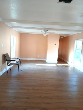 a view of a room with wooden floor