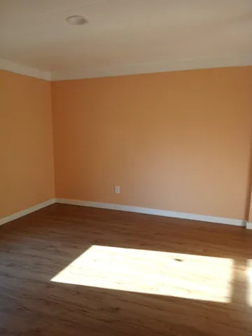 a view of wooden floor and brick walls