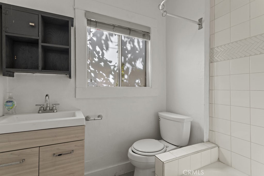 224 West 14th Street Long Beach, CA 90813 - Photo 13 of 31 a bathroom with a toilet sink and mirror