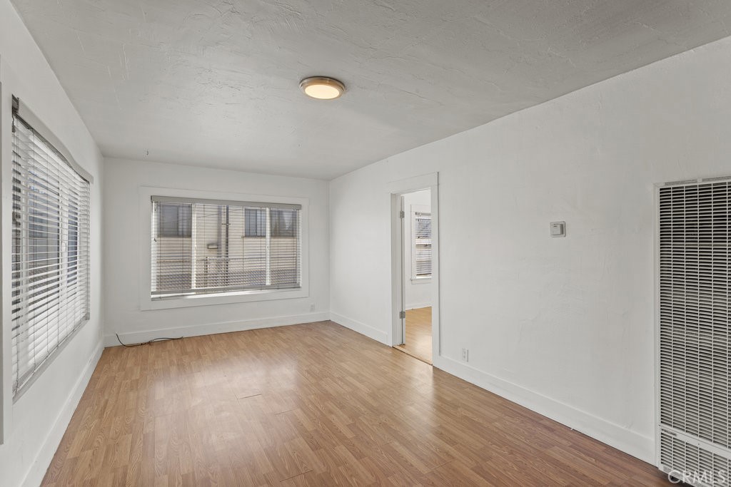224 West 14th Street Long Beach, CA 90813 - Photo 7 of 31 a view of empty room with wooden floor and fan