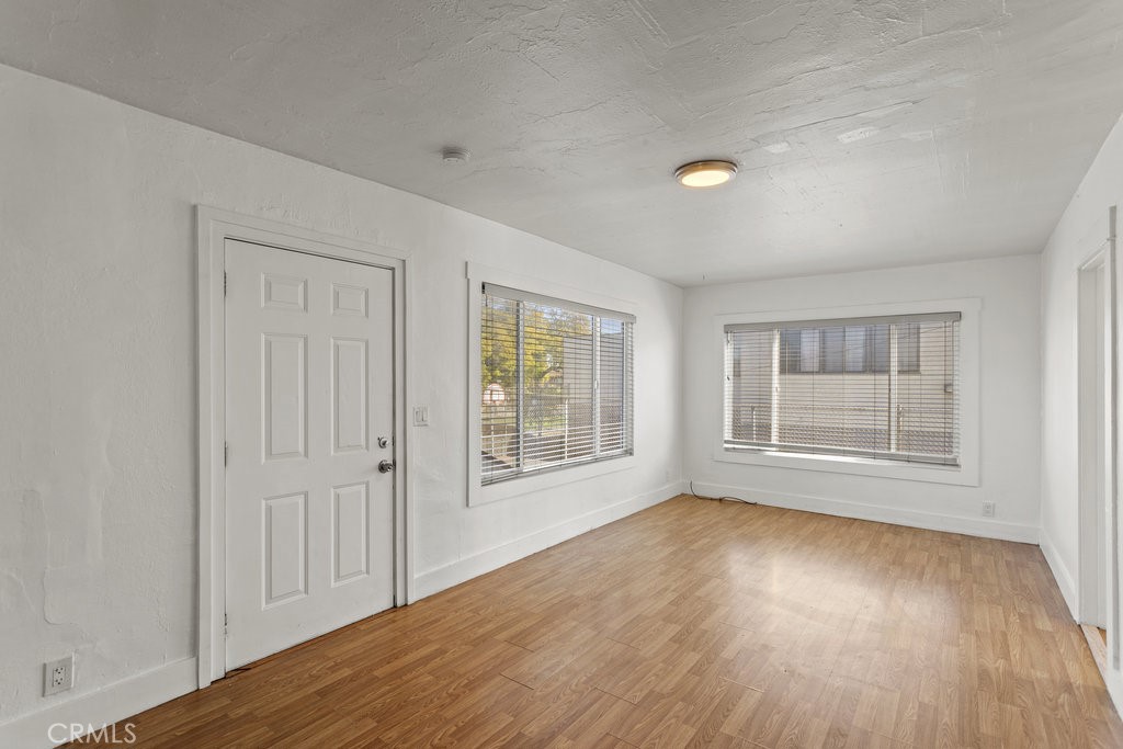 224 West 14th Street Long Beach, CA 90813 - Photo 8 of 31 an empty room with wooden floor and windows