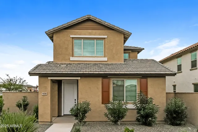 a front view of a house with lake