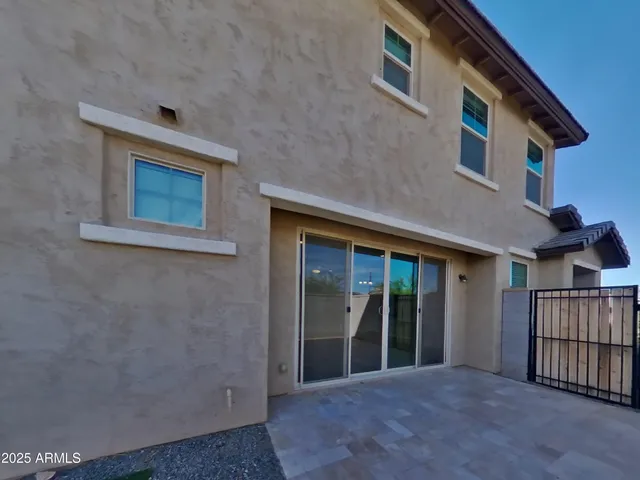 a view of backyard with barbeque grill and wooden fence