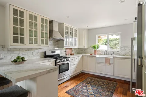 a kitchen with a sink stove and cabinets
