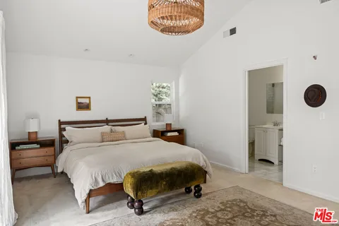 a bedroom with bed and a television