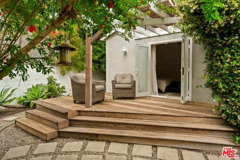 a bathroom with a sink a toilet a large mirror and shower