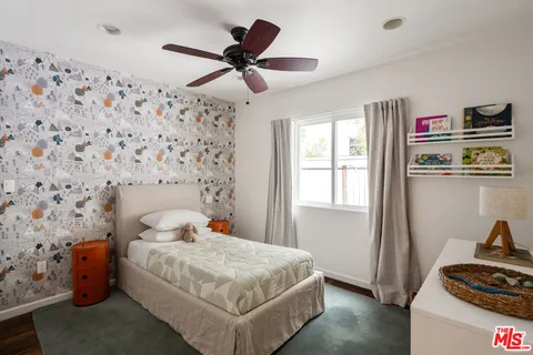 a bedroom with a bed and a couch