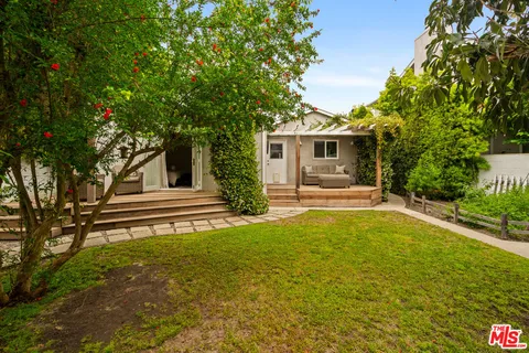 a view of a backyard with swimming pool