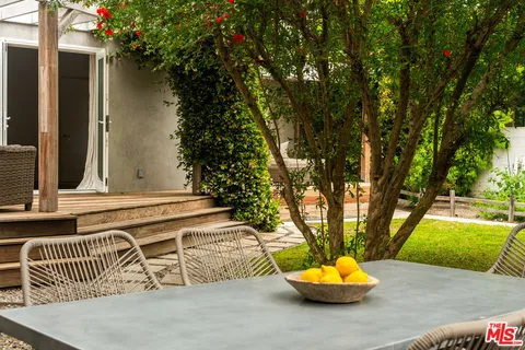 a front view of a house with a tree