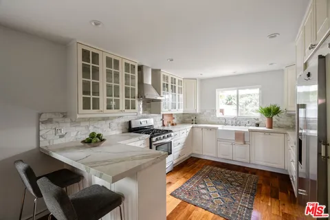 a kitchen with a sink cabinets and window
