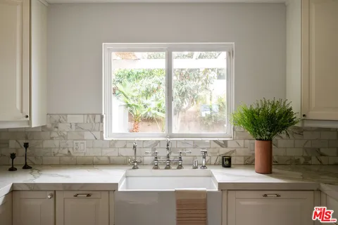 a kitchen with granite countertop a stove and a microwave