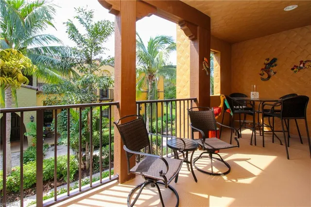 a view of a patio with chairs and table potted plants